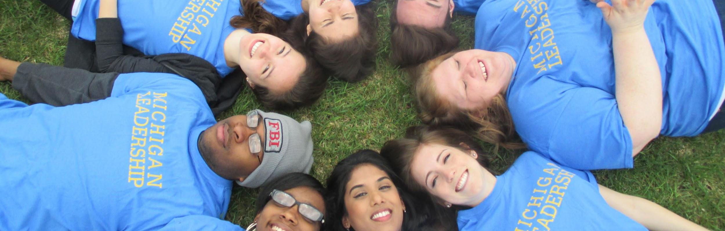 8 students laying on the ground